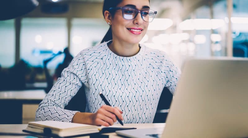 Woman Taking Notes With Laptop