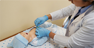 Healthcare provider practicing CPR on baby’s manikin