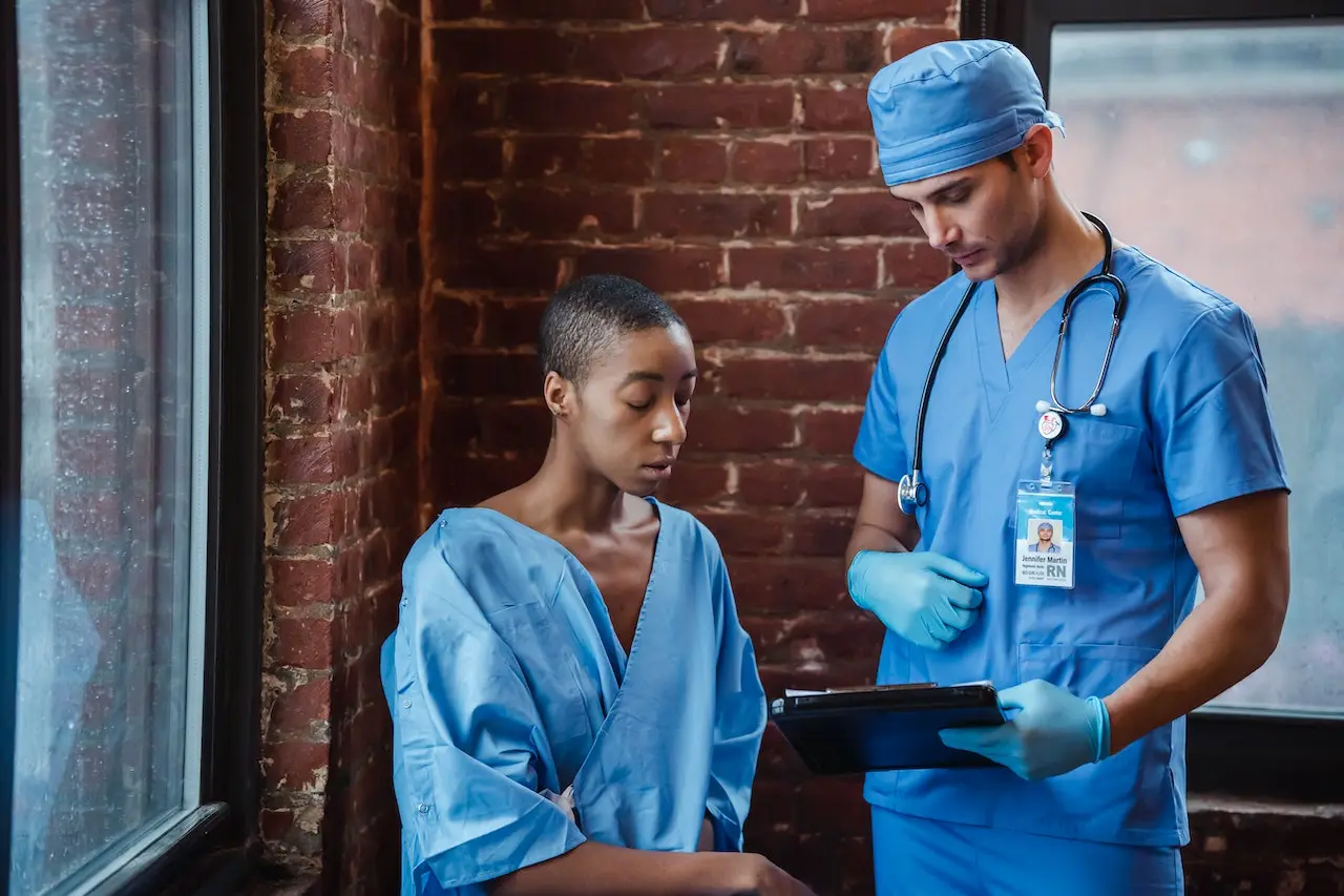 Two nurses standing together, reading some reports