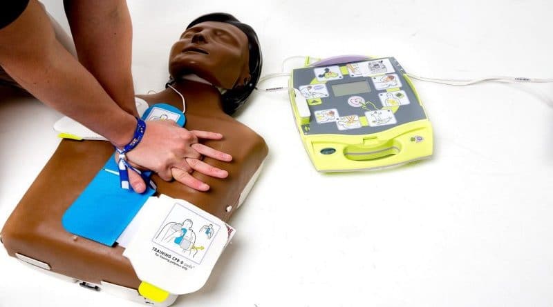 Chest Compressions on Dummy With Defibrillator Online CPR Certification