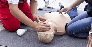 Two men learning rescue breathe using manikin