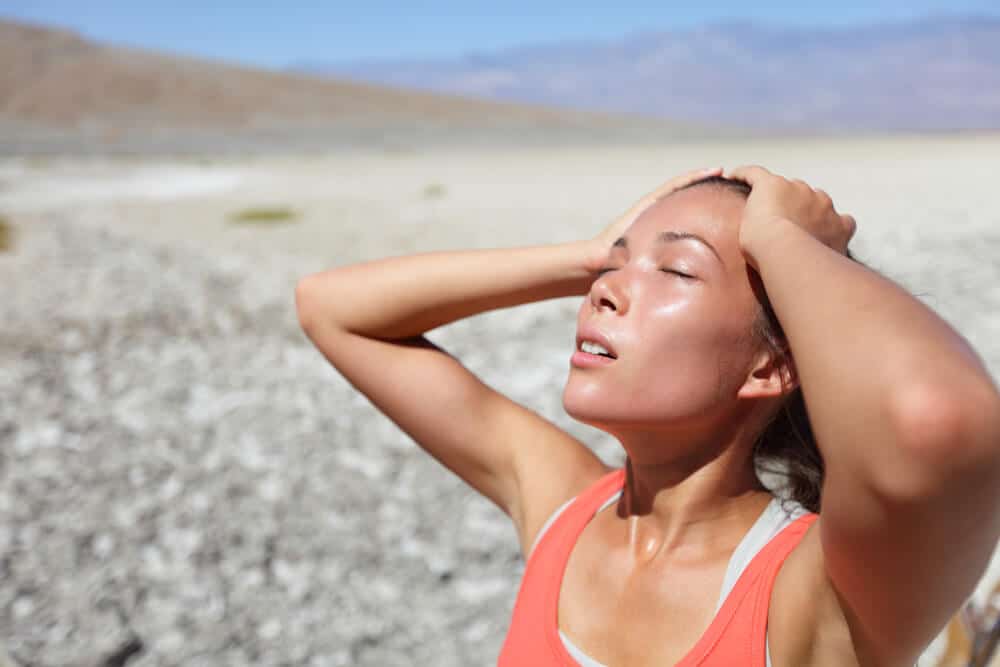 A woman getting the heat stroke near the beach