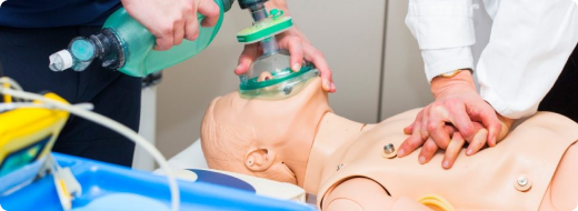 Close-up of hands performing CPR chest compressions on a mannequin