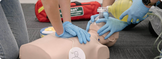 CPR instructor demonstrating the use of an AED during training